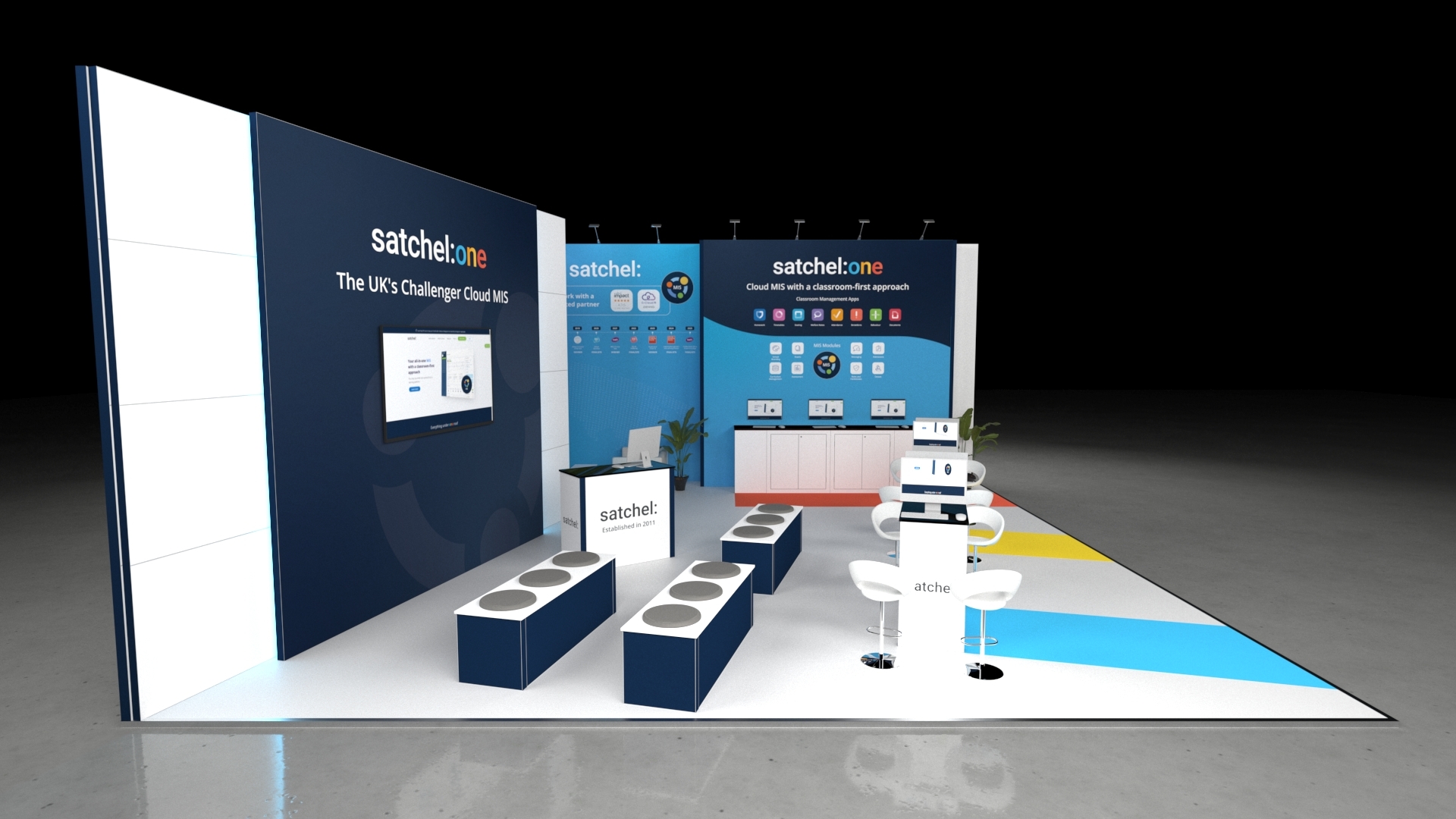 basildon1 Modern exhibition stand with multiple counters, seating areas, digital screens, and informational wall displays in a clean, open layout designed for product demonstrations and visitor engagement