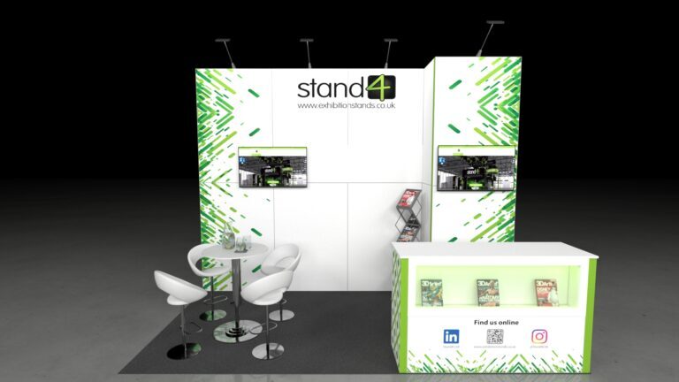 Minimalist exhibition booth with white walls, two screens, bar stools, a round table, and a brochure counter on a grey platform inside a large industrial hall.