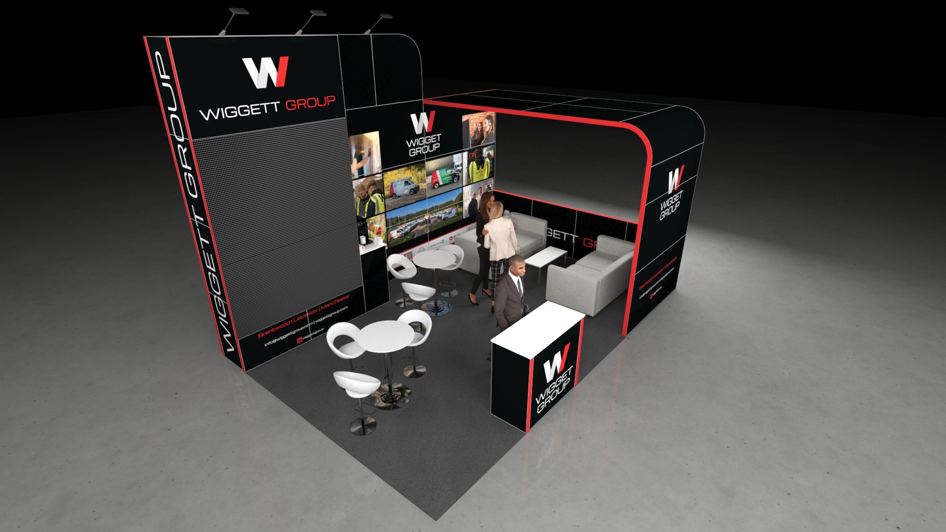 3D render of a modern trade show booth design. The stand features a tall, black and red graphic wall on the left, a semi-enclosed lounge area with grey sofas on the right, and high-top white tables with stylized stools for networking in the centre.